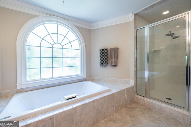bathroom with a stall shower, tile patterned floors, crown molding, and a garden tub
