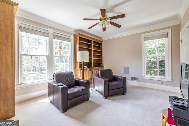 sitting room featuring a ceiling fan, light carpet, baseboards, visible vents, and ornamental molding