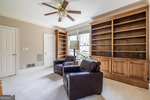 sitting room featuring visible vents, baseboards, ornamental molding, a ceiling fan, and light carpet