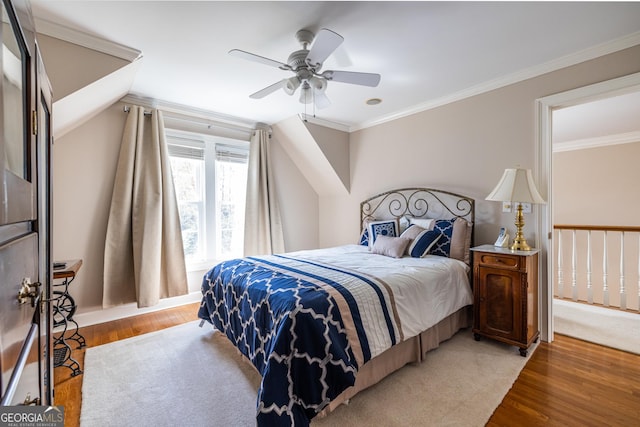 bedroom featuring crown molding, light wood-style floors, and ceiling fan
