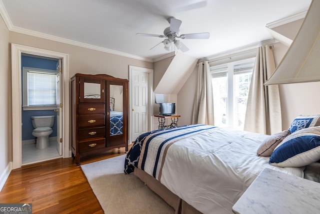 bedroom featuring ornamental molding, baseboards, ensuite bathroom, and wood finished floors