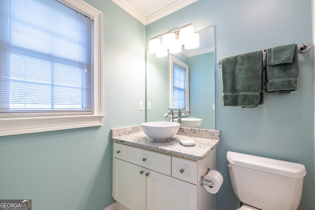 half bathroom featuring toilet, vanity, and ornamental molding