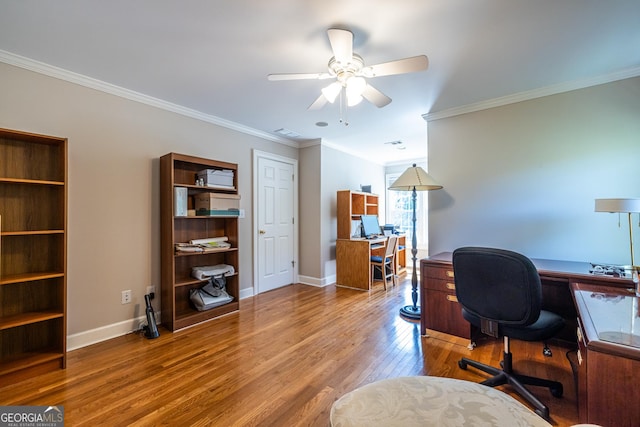 office featuring visible vents, baseboards, ceiling fan, wood finished floors, and ornamental molding
