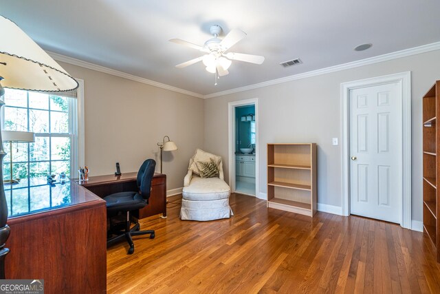 office space with wood finished floors, crown molding, and visible vents