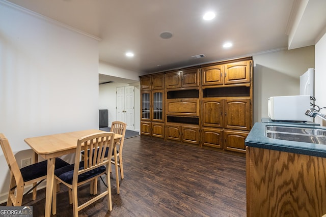 dining room with visible vents, recessed lighting, ornamental molding, and dark wood-type flooring