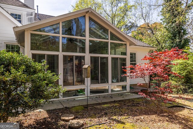 rear view of property with a sunroom