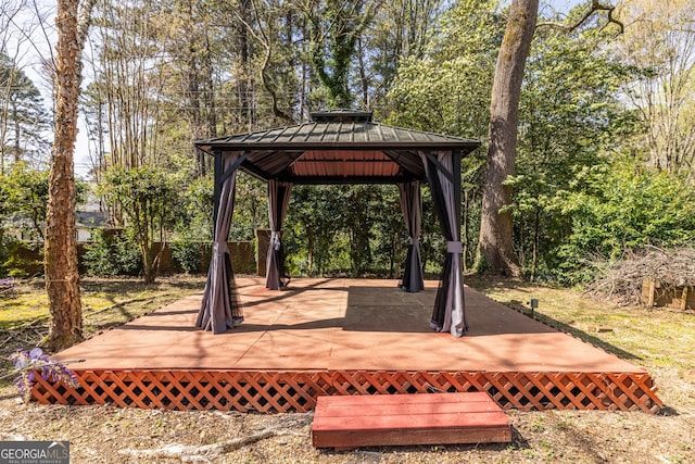 wooden terrace featuring a gazebo