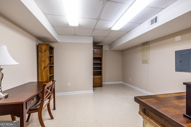home office with visible vents, electric panel, baseboards, light floors, and a drop ceiling
