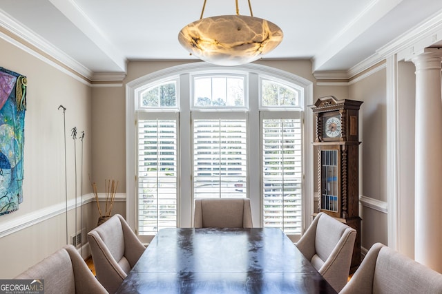 dining area featuring crown molding and decorative columns