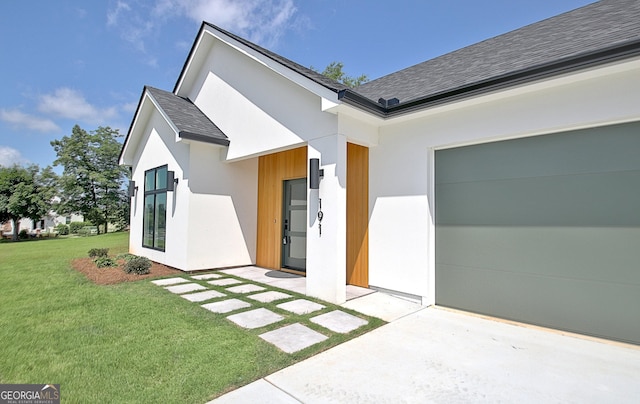 191 Lagrange St, Newnan, GA 30263 - view of front facade with a shingled roof, stucco siding, a front yard, and a garage