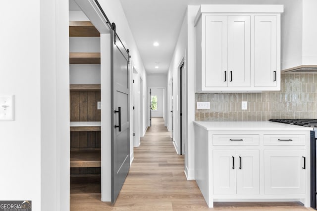 191 Lagrange St, Newnan, GA 30263 - hallway featuring light wood-style flooring, a barn door, and recessed lighting