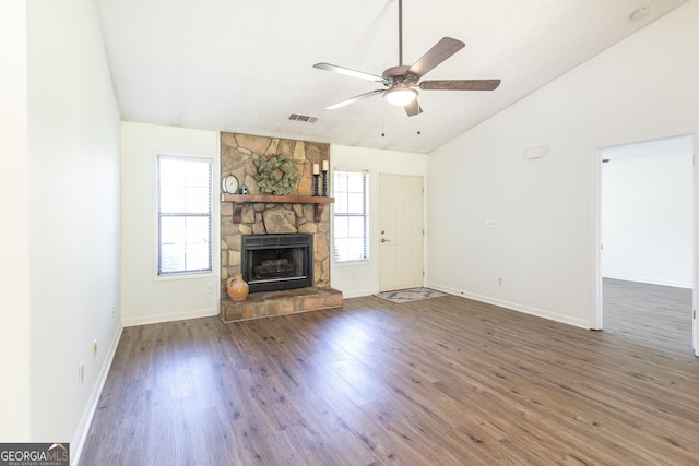 260 Peachtree Ln, Newnan, GA 30265 - unfurnished living room with vaulted ceiling, a stone fireplace, wood finished floors, a ceiling fan, and baseboards
