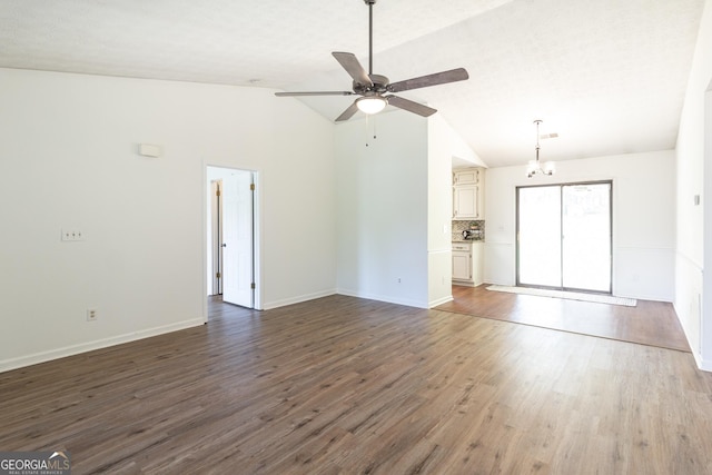 260 Peachtree Ln, Newnan, GA 30265 - unfurnished living room featuring ceiling fan, wood finished floors, a chandelier, high vaulted ceiling, and baseboards