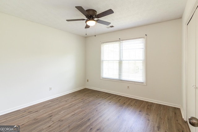 260 Peachtree Ln, Newnan, GA 30265 - unfurnished bedroom with wood finished floors, a closet, baseboards, and a ceiling fan