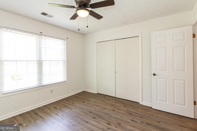 260 Peachtree Ln, Newnan, GA 30265 - unfurnished bedroom with wood finished floors, a closet, baseboards, and a ceiling fan