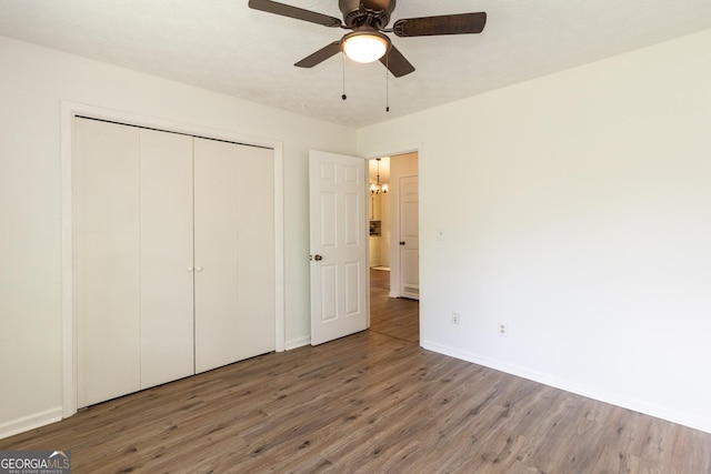 260 Peachtree Ln, Newnan, GA 30265 - unfurnished bedroom featuring wood finished floors, baseboards, a closet, and a ceiling fan