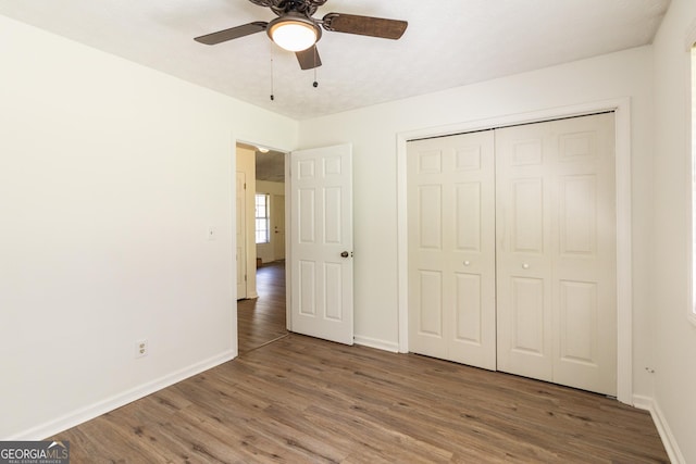 260 Peachtree Ln, Newnan, GA 30265 - unfurnished bedroom featuring wood finished floors, baseboards, a closet, and ceiling fan
