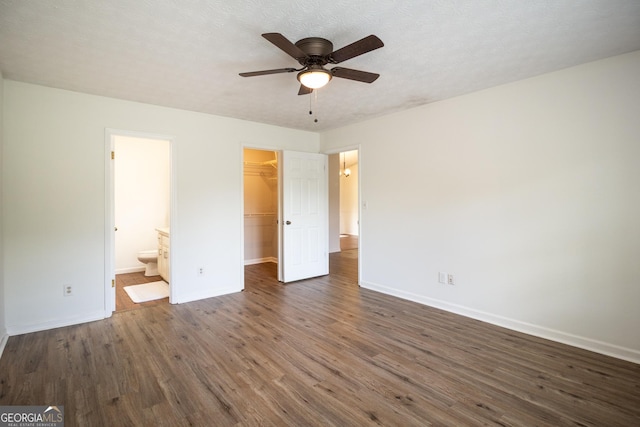 260 Peachtree Ln, Newnan, GA 30265 - unfurnished bedroom featuring dark wood-type flooring, a spacious closet, baseboards, a closet, and ensuite bath