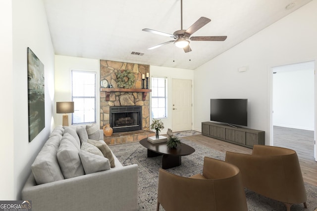 260 Peachtree Ln, Newnan, GA 30265 - living area with vaulted ceiling, wood finished floors, a stone fireplace, a ceiling fan, and baseboards