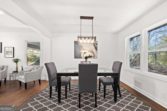 dining space with baseboards, visible vents, and dark wood-style flooring