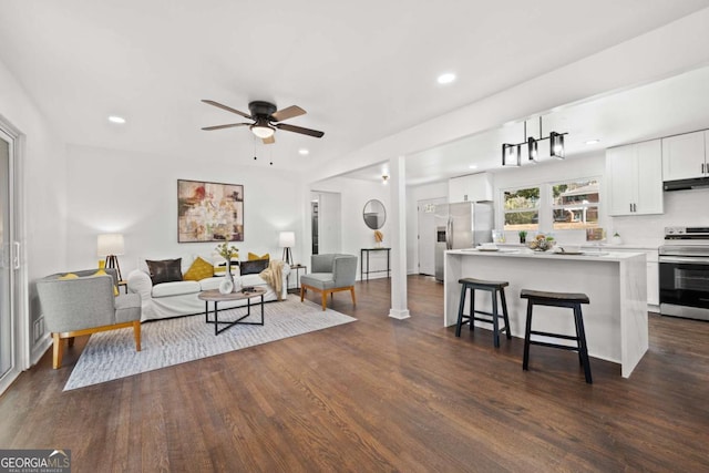 living area featuring dark wood finished floors, recessed lighting, and a ceiling fan