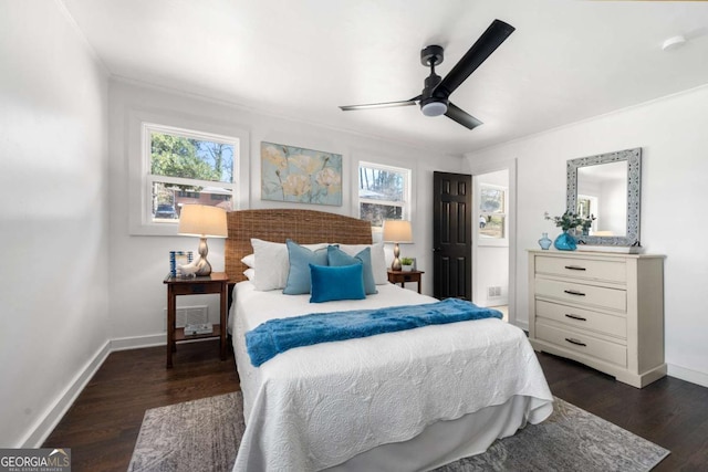 bedroom featuring baseboards, multiple windows, ceiling fan, and dark wood finished floors