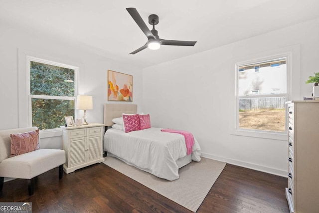 bedroom with dark wood-style floors, baseboards, and ceiling fan