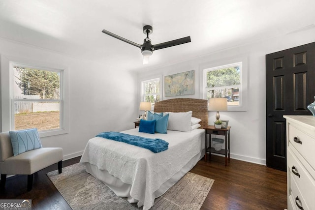 bedroom featuring baseboards, dark wood-style floors, and a ceiling fan