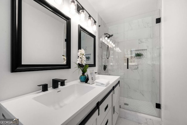 bathroom featuring marble finish floor, double vanity, a sink, and a marble finish shower