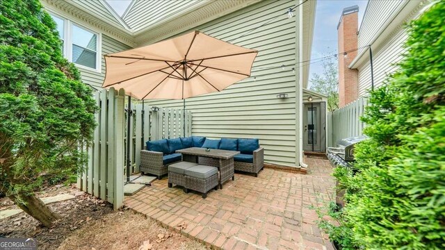 view of patio / terrace with outdoor lounge area and fence