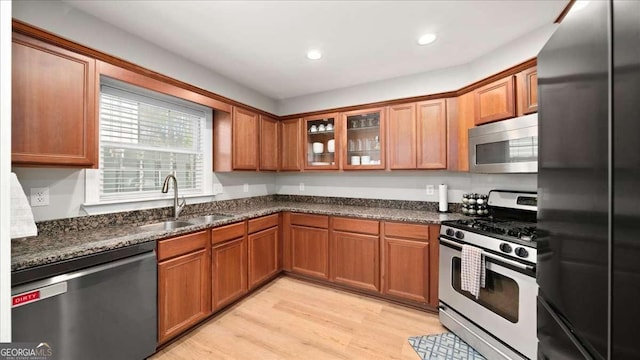 kitchen featuring a sink, stainless steel appliances, and brown cabinetry