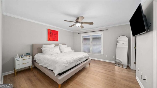 bedroom featuring light wood-style flooring, ornamental molding, baseboards, and ceiling fan