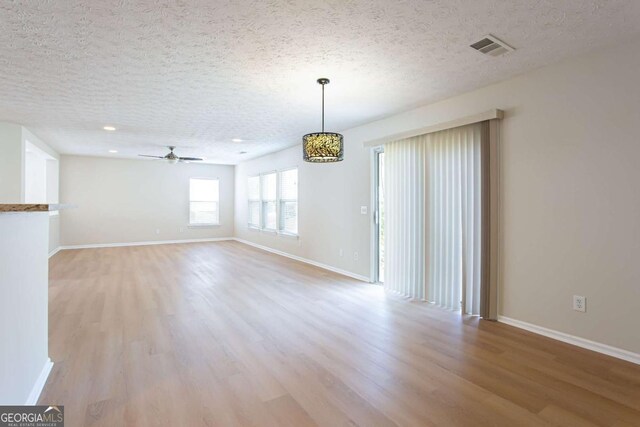 1924 Sweet Flag Rd, Lawrenceville, GA 30045 - empty room with a textured ceiling, light wood-style floors, ceiling fan, baseboards, and recessed lighting