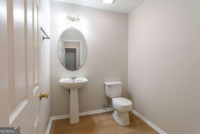 1924 Sweet Flag Rd, Lawrenceville, GA 30045 - half bath with wood finished floors, toilet, and baseboards