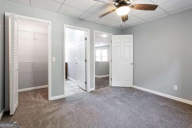 1924 Sweet Flag Rd, Lawrenceville, GA 30045 - unfurnished bedroom featuring carpet, a walk in closet, a drop ceiling, a closet, and baseboards