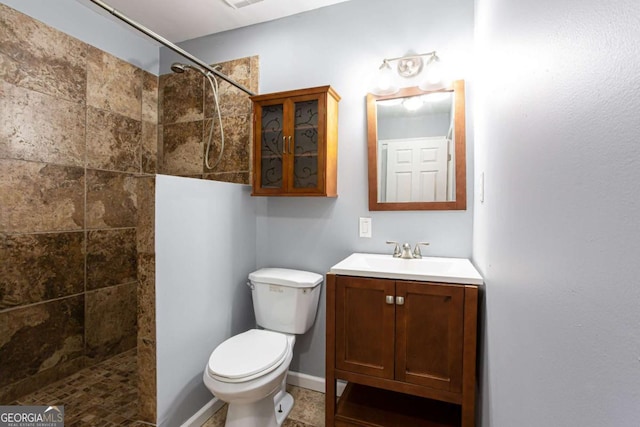 1924 Sweet Flag Rd, Lawrenceville, GA 30045 - full bathroom featuring a tile shower, toilet, vanity, and baseboards