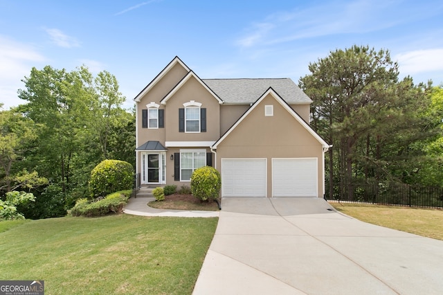 view of front of home with stucco siding, driveway, fence, and a front yard