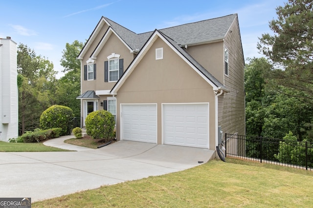view of front of home with concrete driveway, stucco siding, a front lawn, and fence