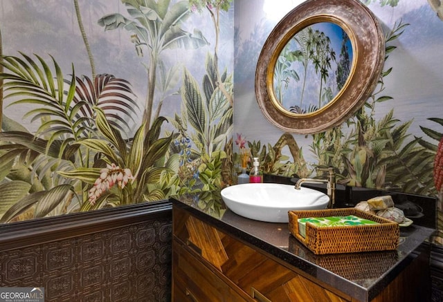 bathroom with wallpapered walls and vanity