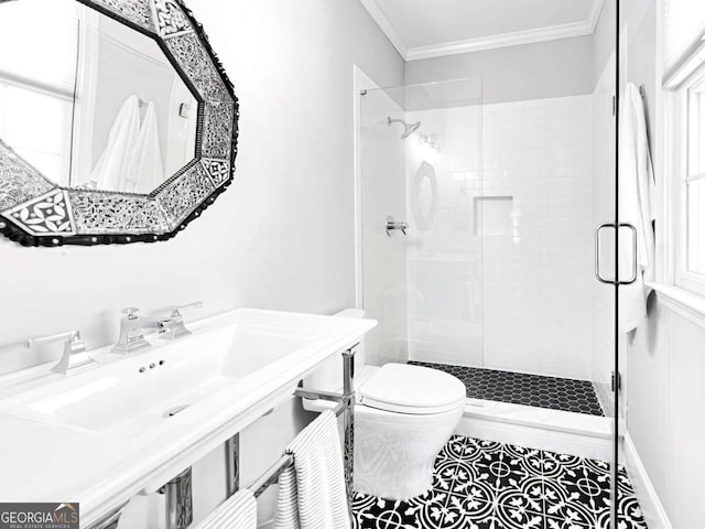 full bath with a stall shower, crown molding, toilet, and a sink