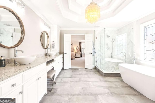 full bathroom with double vanity, ornamental molding, a sink, and a stall shower