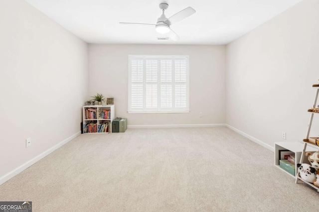 rec room with baseboards, ceiling fan, and carpet flooring