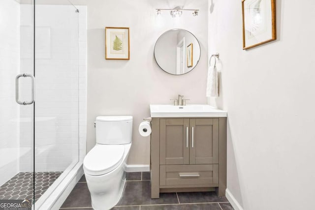 bathroom with tile patterned flooring, toilet, a stall shower, and vanity