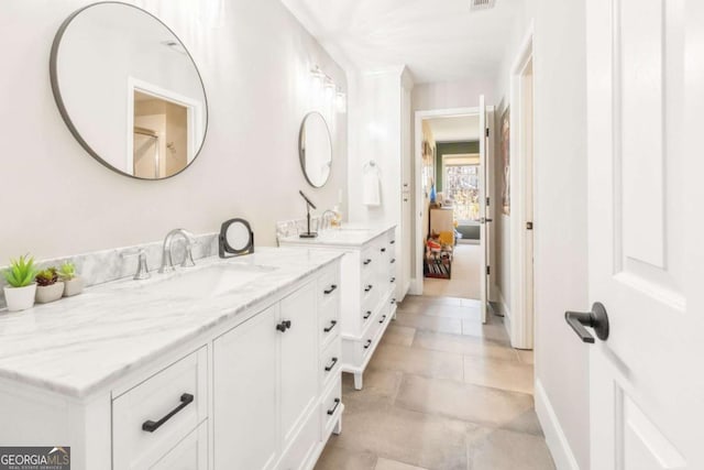 ensuite bathroom featuring vanity and ensuite bath