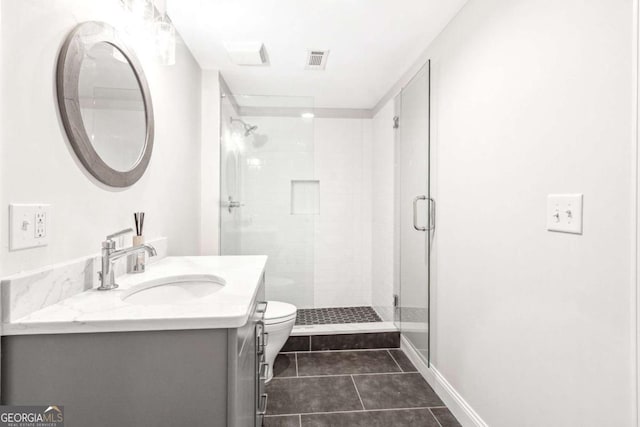 full bathroom with vanity, toilet, tile patterned floors, a stall shower, and visible vents