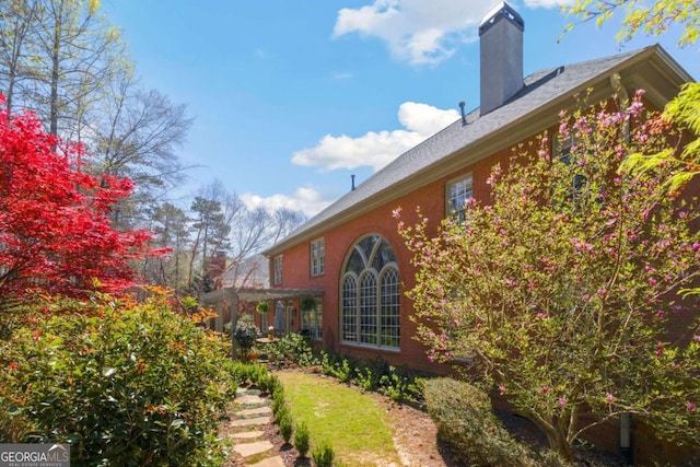 view of side of home featuring a chimney