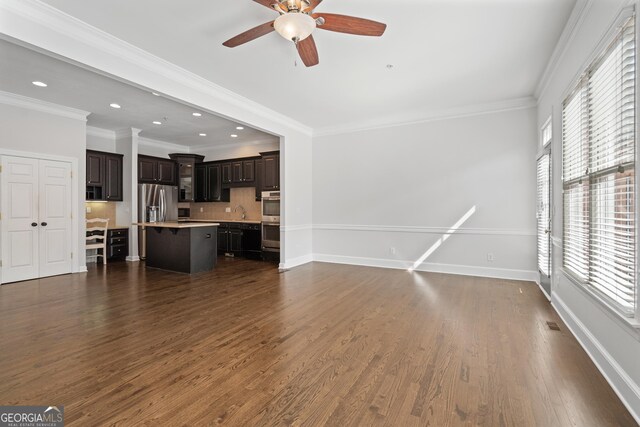 living room featuring baseboards, a wealth of natural light, and dark wood finished floors