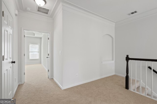 hallway featuring an upstairs landing, carpet, crown molding, and visible vents