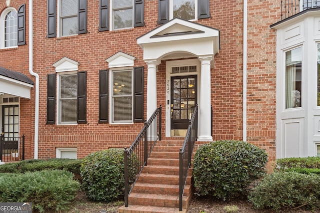 view of exterior entry with brick siding
