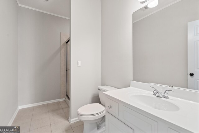 full bathroom with crown molding, toilet, vanity, a stall shower, and tile patterned flooring